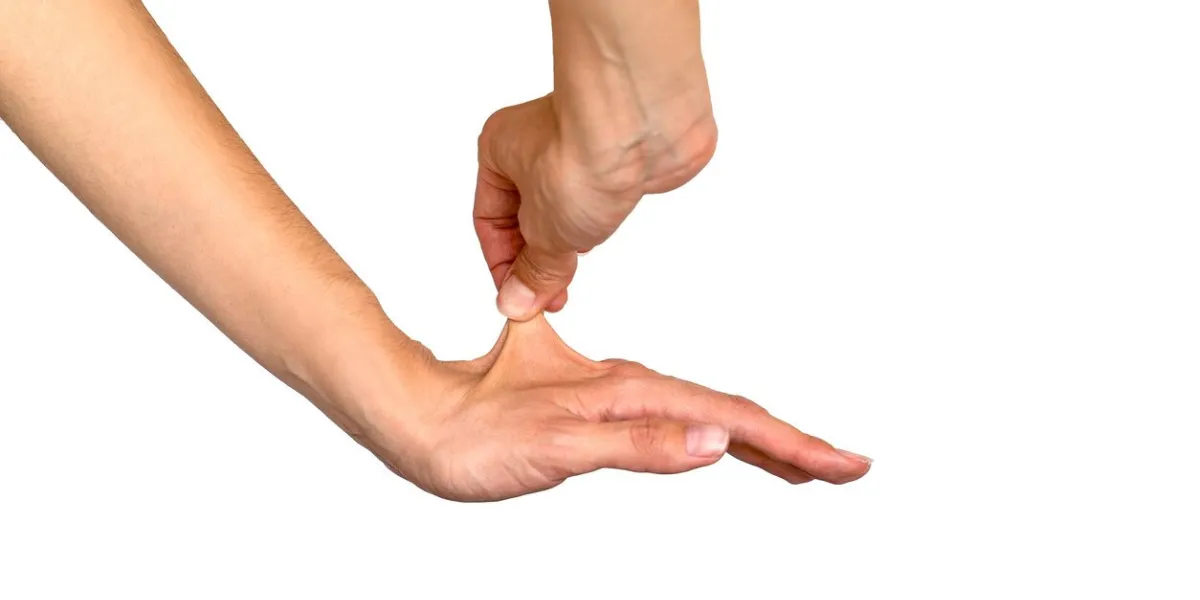 hand stretching the super elastic skin of another hand
