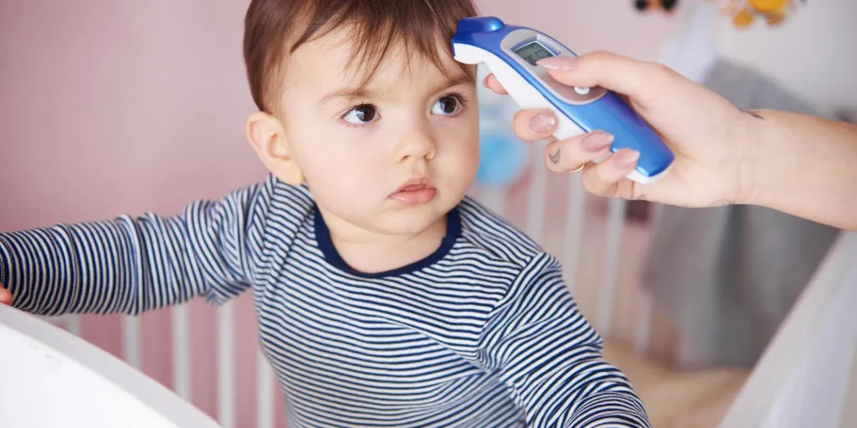 mother is taking baby temperature