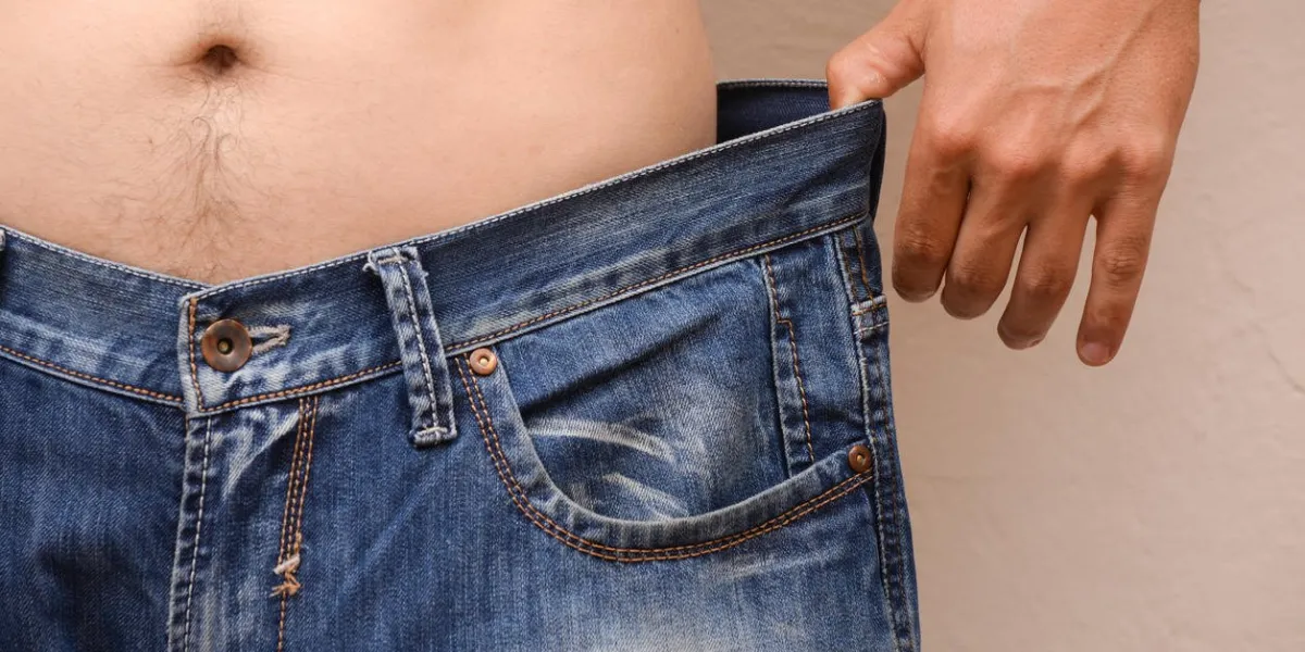 men wearing big jeans after diet