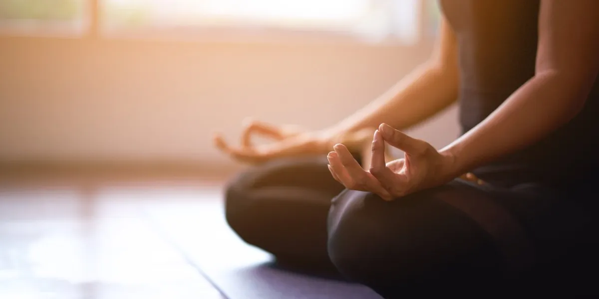 women in meditation while practicing yoga in a training room happy, calm and relaxing