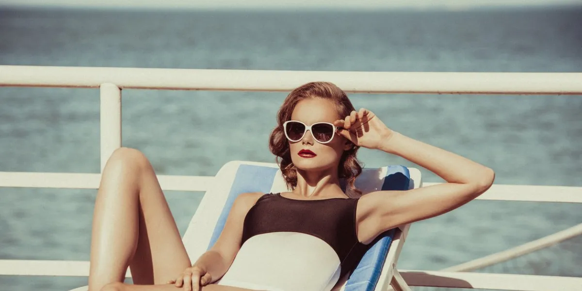 beautiful brown hair woman wearing bikini young girl model in sunglasses and elegant black and white sexy swimsuit lingerie near swimming pool with clear blue water, full relax vintage sunbathe