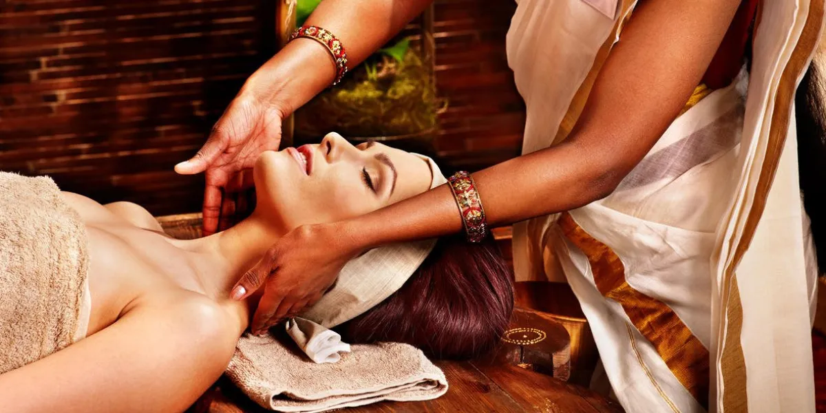 woman having facial ayurveda spa treatment