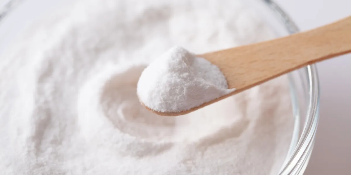 chemical powder on a wooden spoon aspartame e951 over a bowl