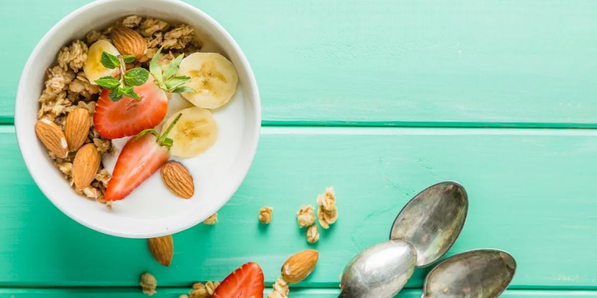 breakfast - strawberry and banana muesli with yogurt, copy space