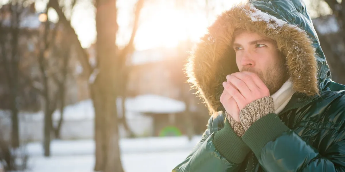 cold and loneliness male in down coat with fur hood feel warm and comfortable favorite season guy green puffer coat man enjoy winter landscape nature is beautiful place for thoughts
