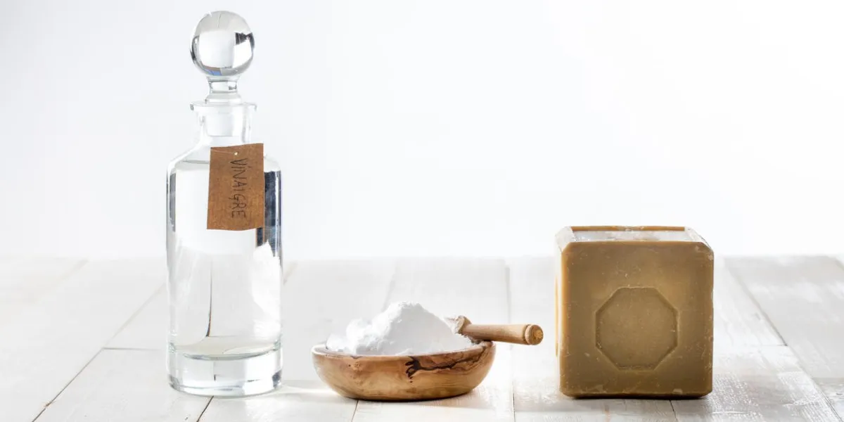 green domestic housekeeping and sustainable cleaning washing with chic homemade softener made of vinegar and baking soda on copy space wooden background