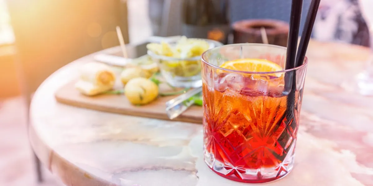 mezcal negroni cocktail italian aperitivo on the table in the open area of restaurante