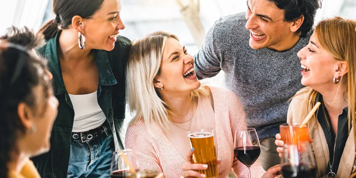 multiracial friends celebrating summer party drinking fancy cock
