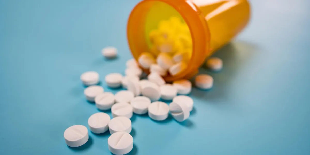 pile of white pills on blue background