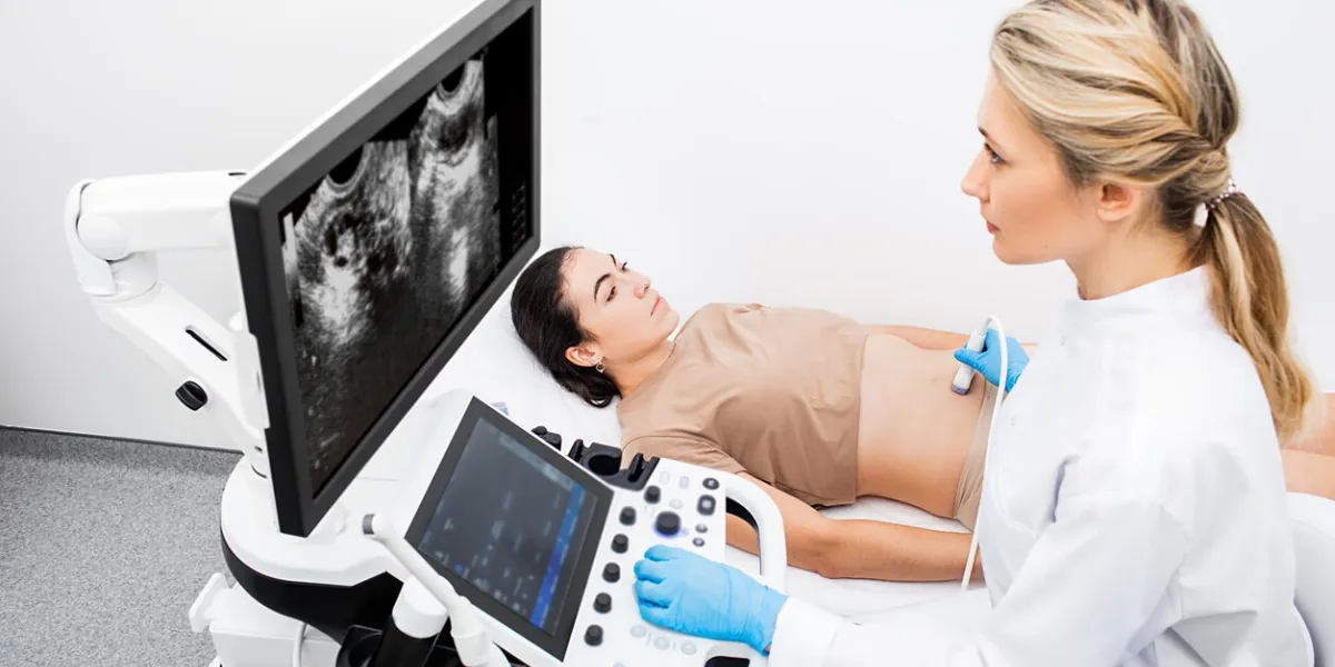 woman having an ultrasound examination of uterus and ovaries at the gynecologist office in a modern clinic women's health