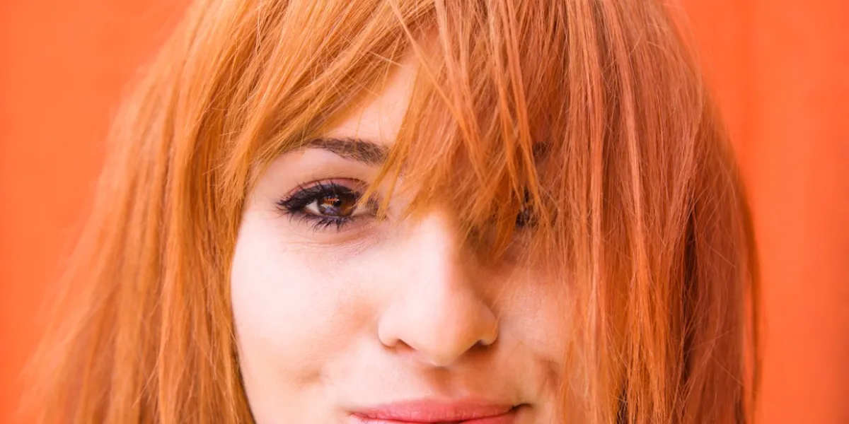 young redheaded woman looking at viewer with funny expression