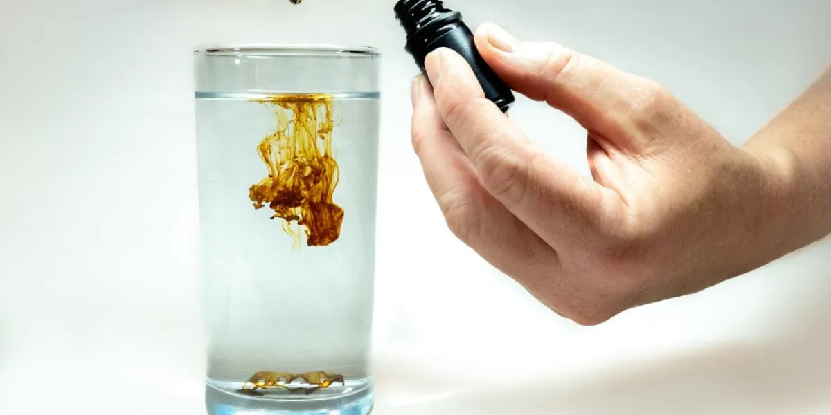 a,single,drop,of,concentrated,colloidal,silver,being,diluted,in