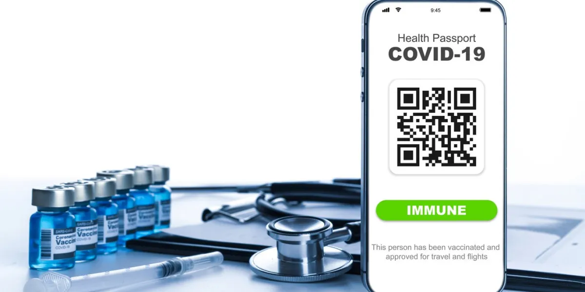 health certificate medical equipment with coronavirus vaccine certificate on phone screen, healthcare charts, syringe and doctor stethoscope on hospital white background digital passport concept