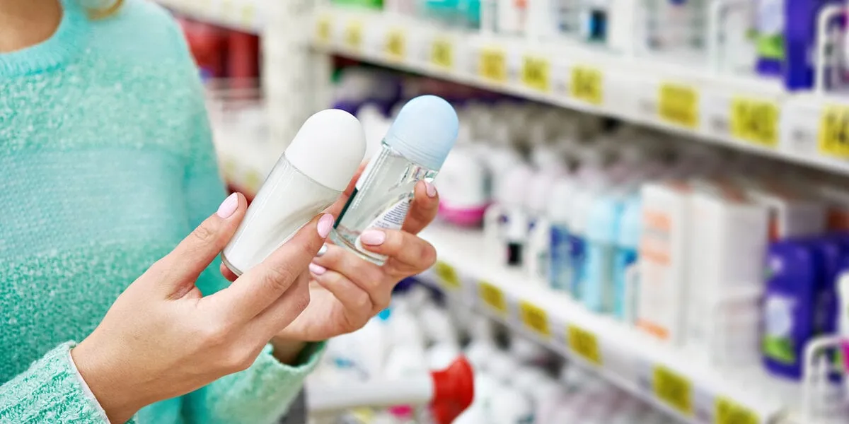 woman in shop chooses deodorant closeup