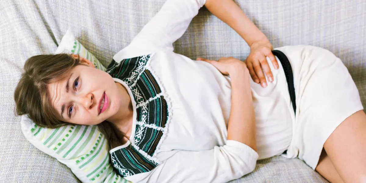 portrait of beautiful unhappy girl having pangs of belly-ache