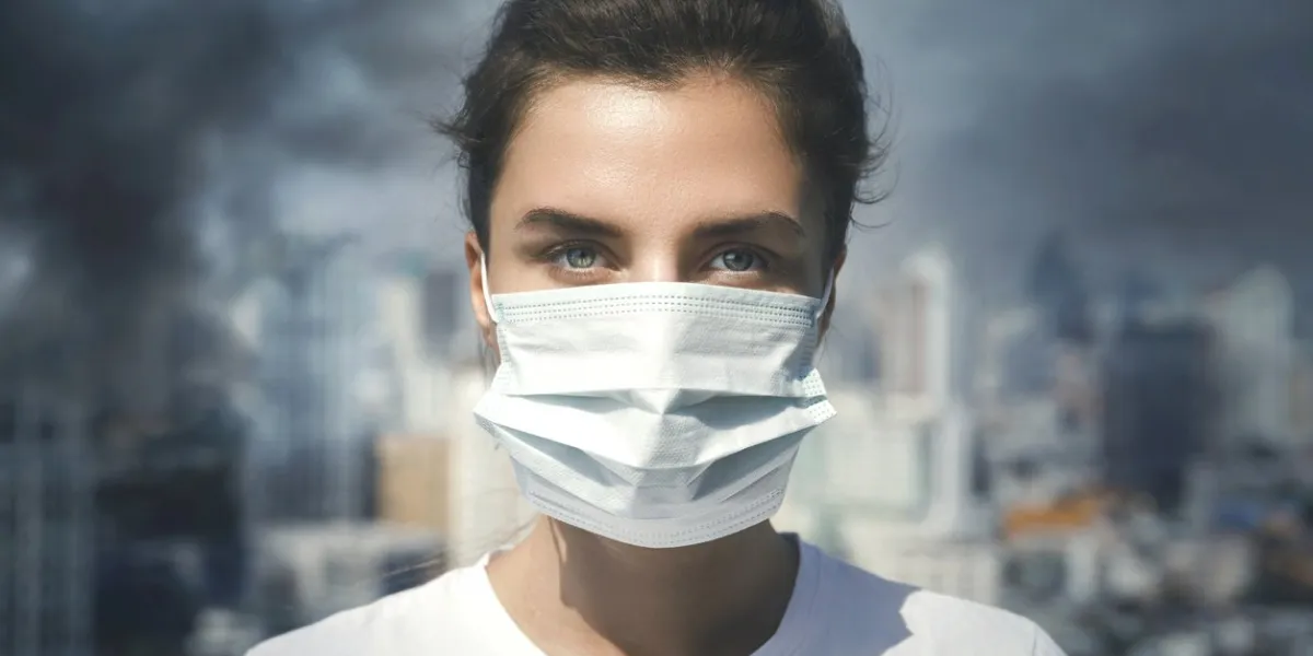 air pollution in the city woman wearing face mask for protection