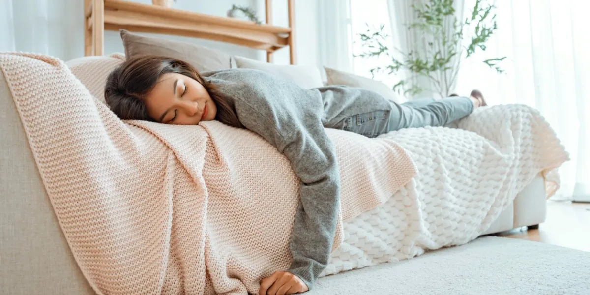 asian woman feels tired so she sleeps on sofa at home, feels mental or physical exhaustion, looking melancholic lack of energy after sleepless night, fatigue concept