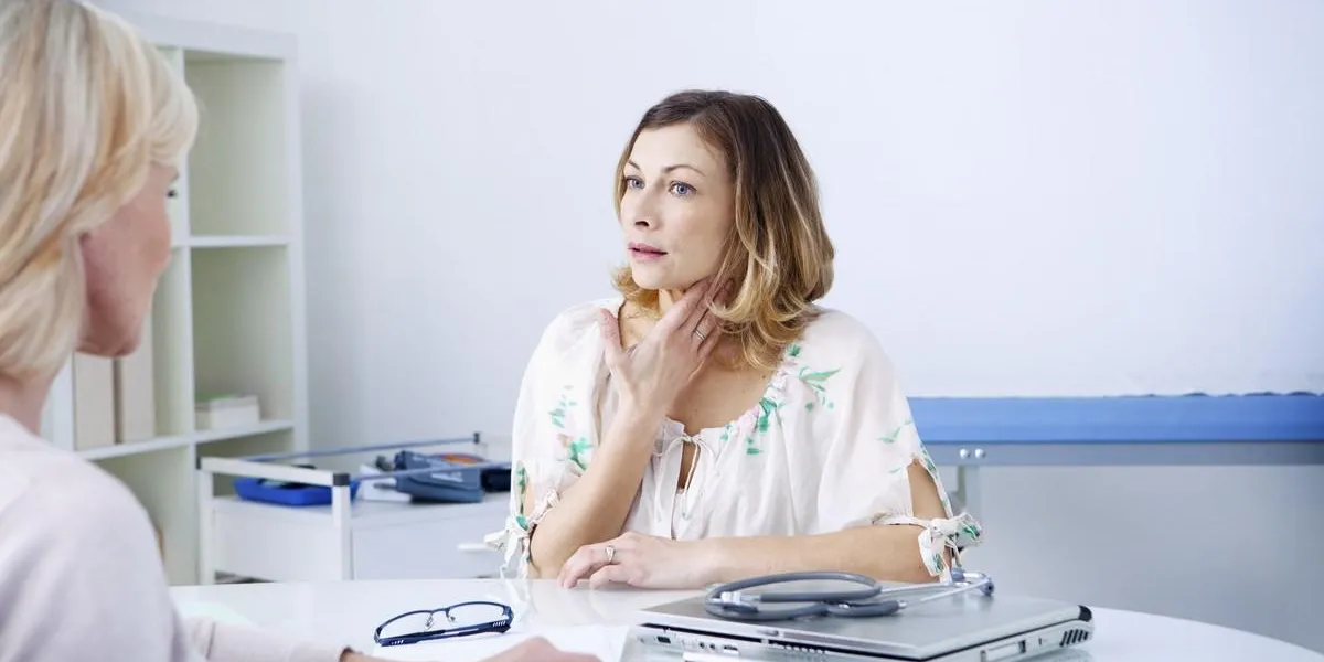 female patient consulting for sore throat