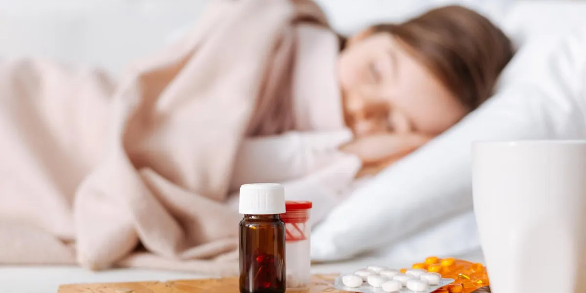 it helps selective focus of medicines while tired sick girl sleeping in the background