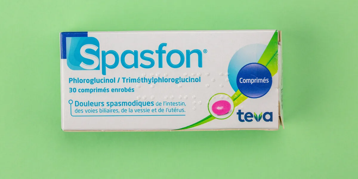 benon, france - november 10, 2019 closeup on spasfon box it is an antispasmodic drug to relieve abdominal pain or gynecological green background