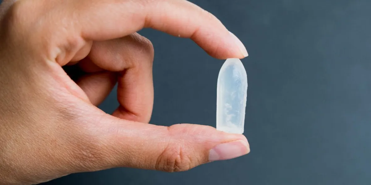 rectal candle in hand on black background