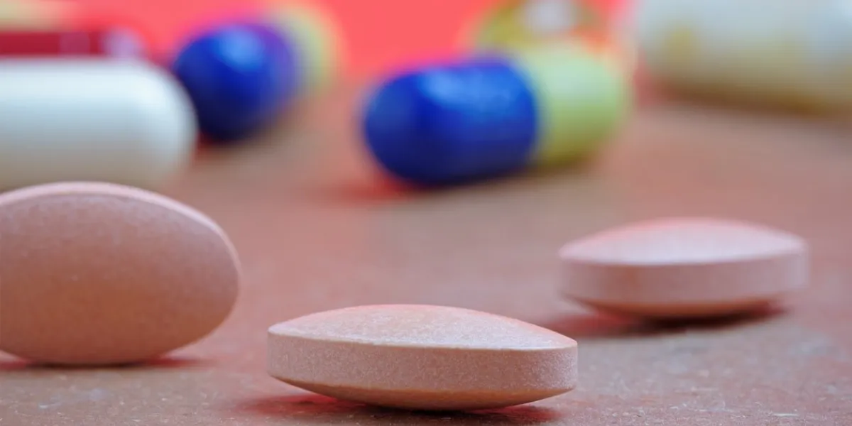 close up of statin tablet or generic pill with out of focus tablets in background