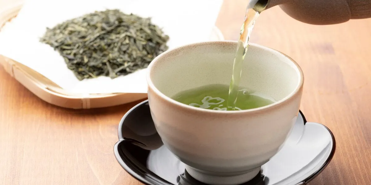 warm green tea on a wooden table