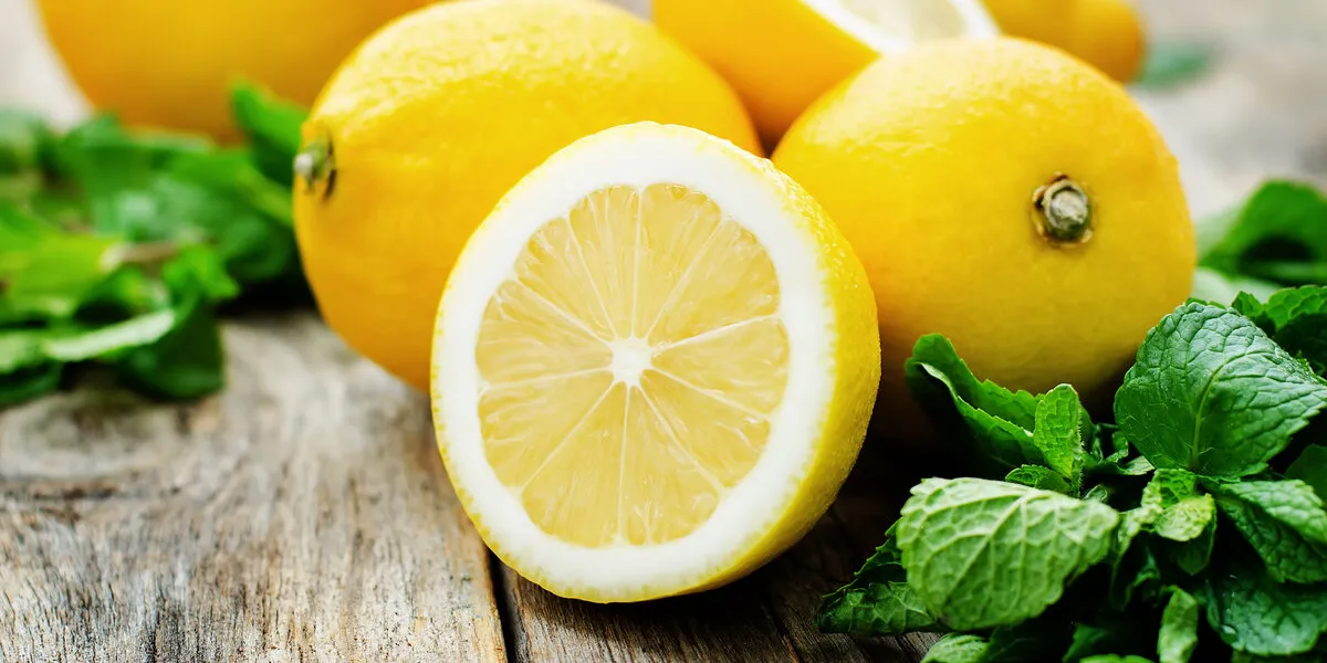 lemons and mint on a dark wood background tinting selective focus