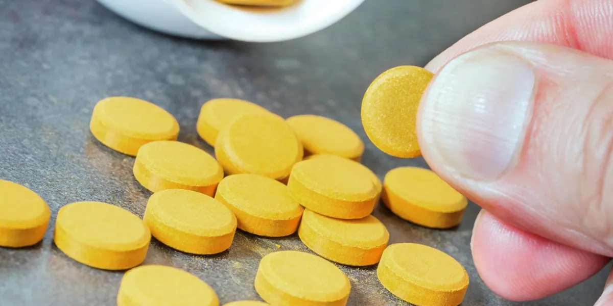 closeup on turmeric tablets, a natural food supplement with multiple virtues