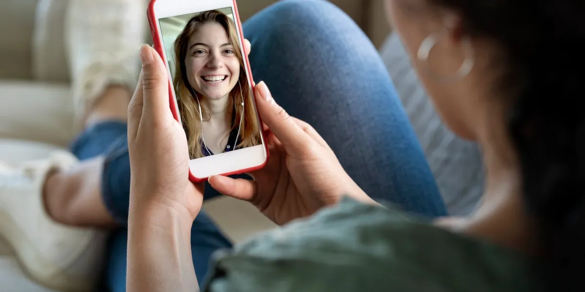 young woman using smartphone for video call