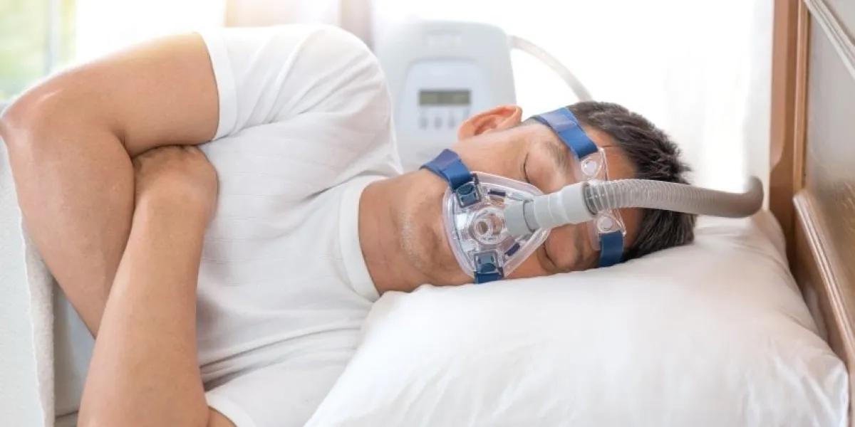 man sleeping in bed wearing cpap mask ,sleep apnea therapyhappy and healthy senior man sleeping deeply on his left side without snoring