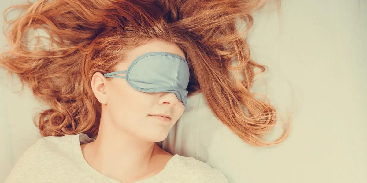 tired woman sleeping in bed wearing blindfold sleep mask young girl taking nap