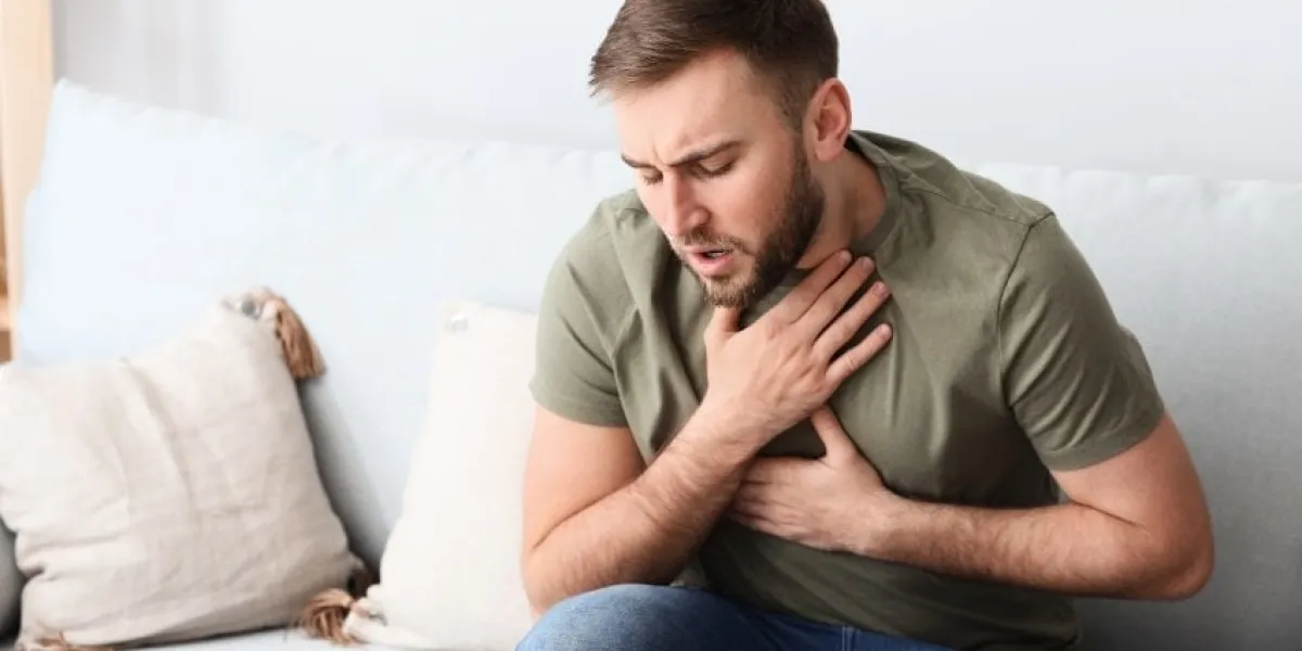 young man having asthma attack at home