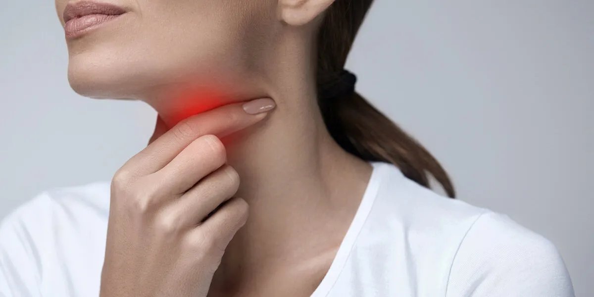 sore throat closeup of beautiful young woman hand touching her ill neck close-up of girl suffering from throat pain, painful swallowing illness, medicine and health care concept high resolution