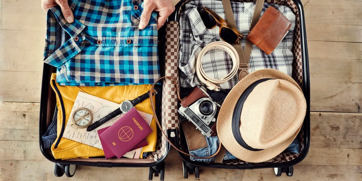 preparing travel suitcase high angle view