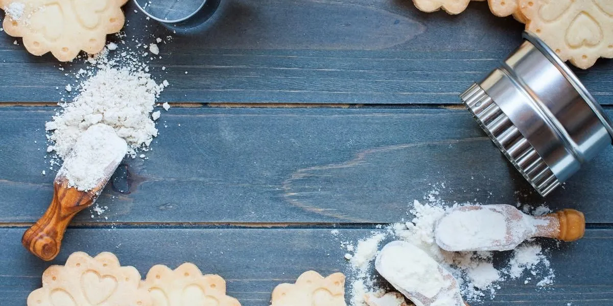 background of baking gluten free shortbread cookies with utensils and ingredients, viewed from above