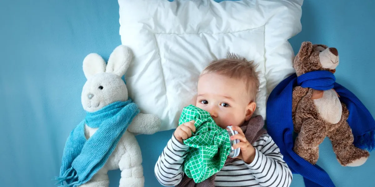 ill boy lying in bed sad child with fever and ice bag on head