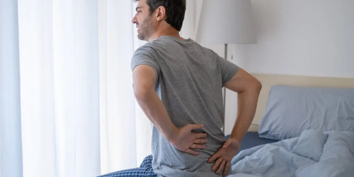 one man waking up and suffering from backache