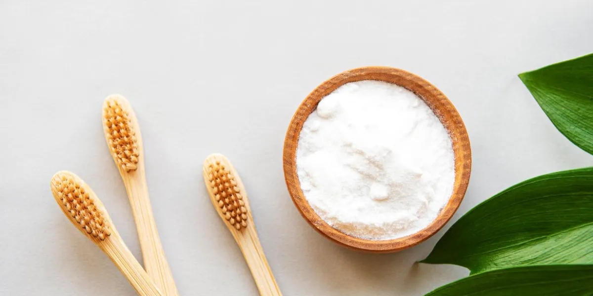 wooden bamboo eco friendly toothbrushes, baking soda on white background dental care and zero waste concept