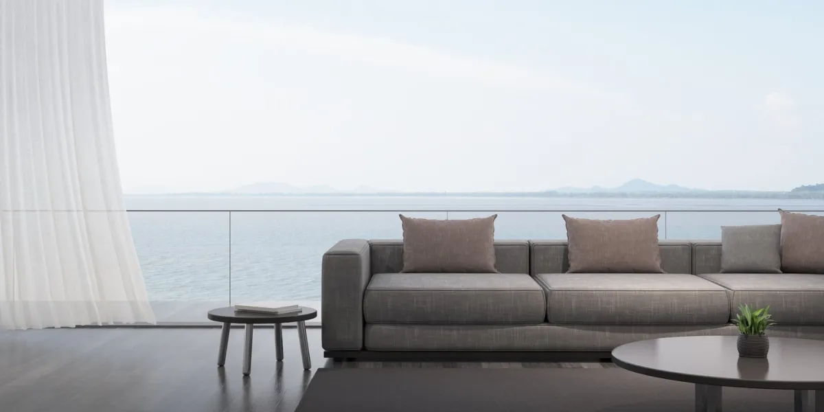 perspective of modern luxury living room with grey sofa on sea view background,idea of family vacation - dark timber interior design, architecture idea of large window system - 3d rendering