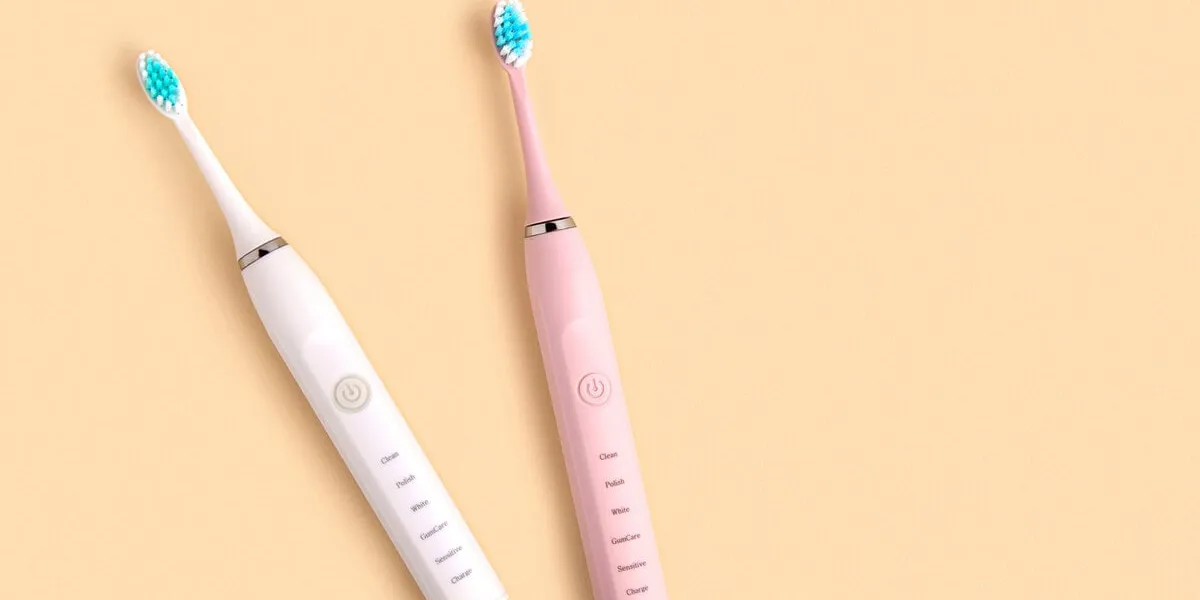 electric toothbrush top view, flat lay, copy space dental care supplies on beige pastel studio background oral hygiene, gum health, healthy teeth modern dental ultrasonic vibration tooth brush sonic smart technology bleaching