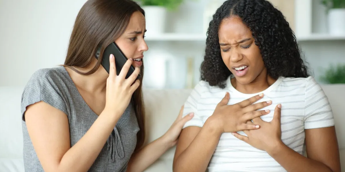 woman chocking and her partner calling doctor at home