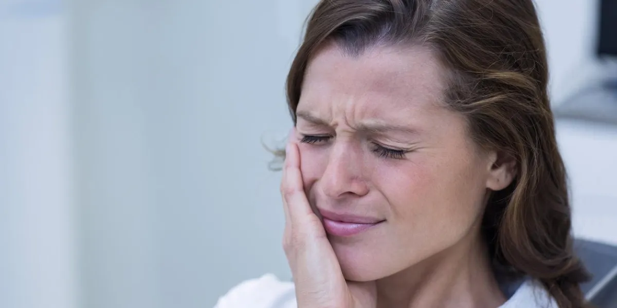 unhappy woman having a toothache in dental clinic