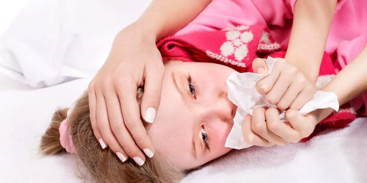 sick little girl with handkerchief in bed