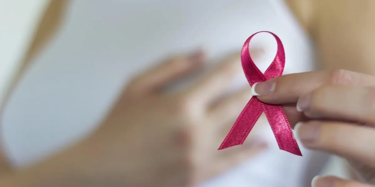 woman hold pink ribbon for breast cancer awareness