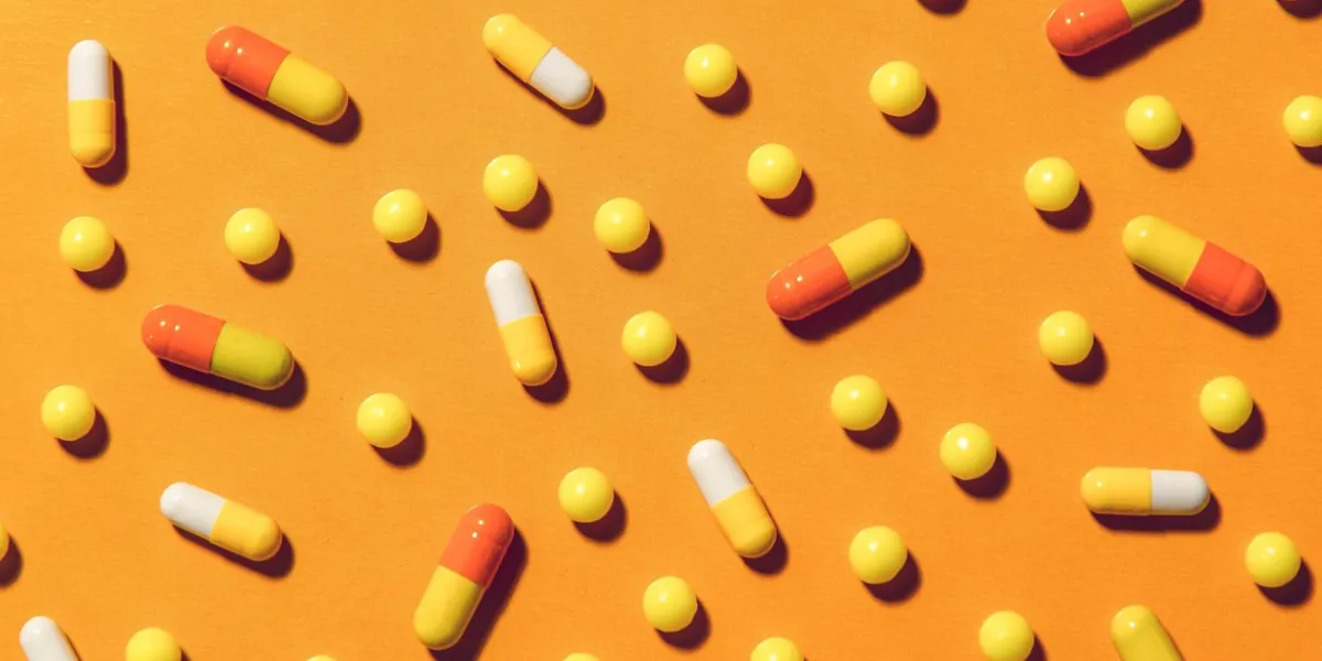 scattering of colorful pills and pills on a bright background vitamins, dietary supplements, medicines, antibiotics - means to maintain immunity and fight against diseases and infections colorful background