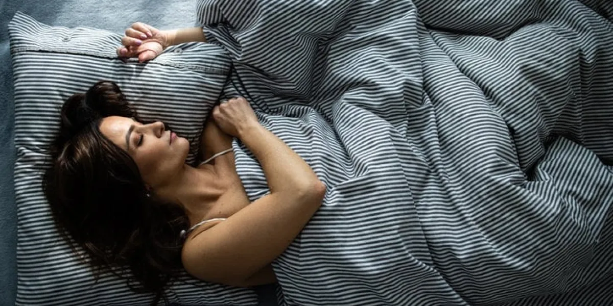 pretty, young woman sleeping in her bed