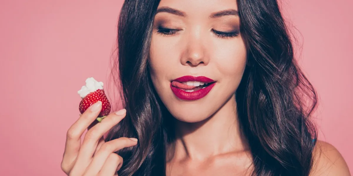 close-up portrait of nice cute luxury lovely sweet attractive adorable wavy-haired lady licking red lips want wish looking at whipped cream dessert isolated over pink pastel background
