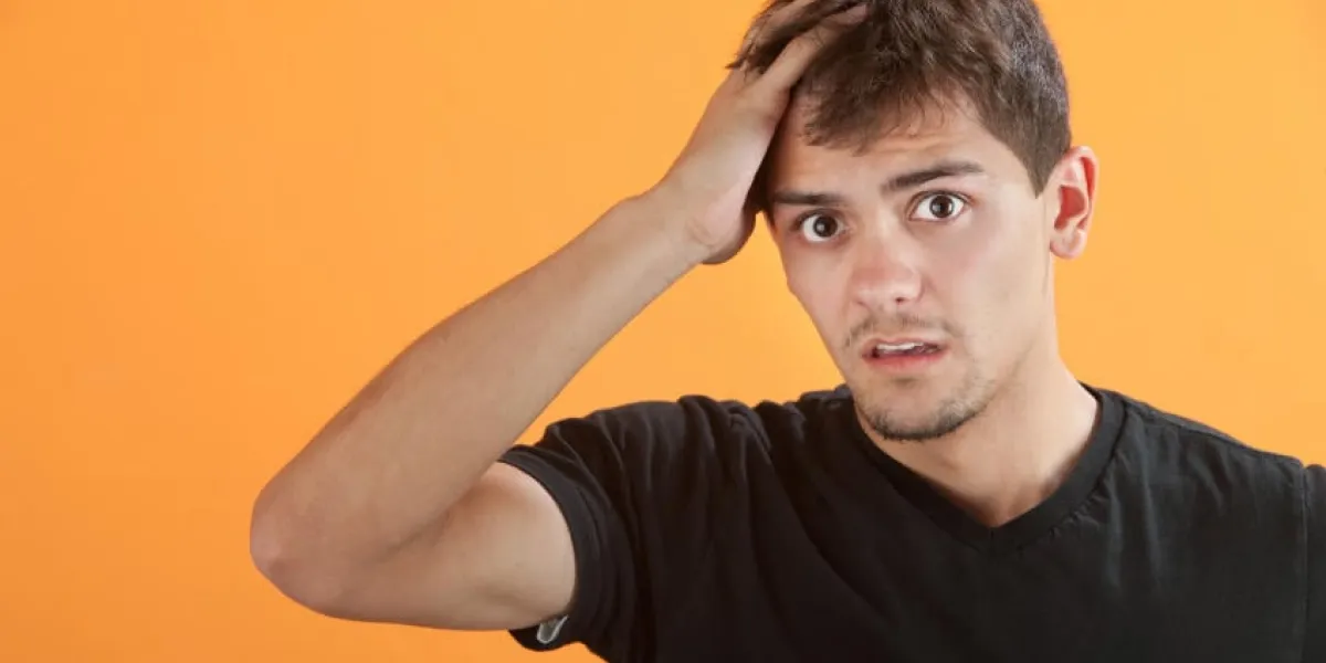 bouleversé adolescent hispanique mâle avec la main sur la tête