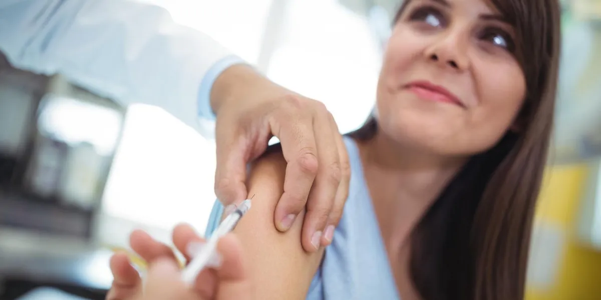 doctor giving an injection to the patient at hospital